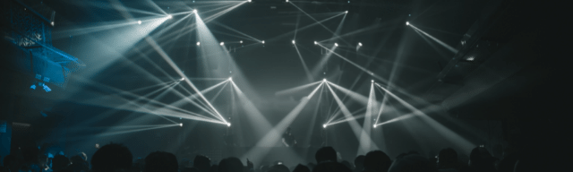Nightclub scene with spotlights and crowd